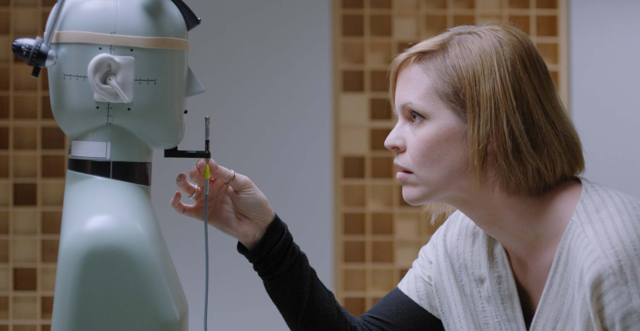 Suzie, der er manager for Acoustic Prototyping-teamet hos Apple, indstiller en mikrofon foran en testdukke i et teknisk laboratorie i Cupertino.